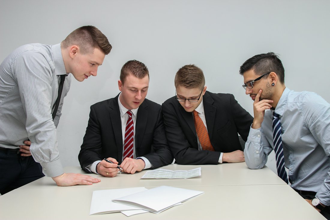 Business professionals reviewing paperwork at a meeting table