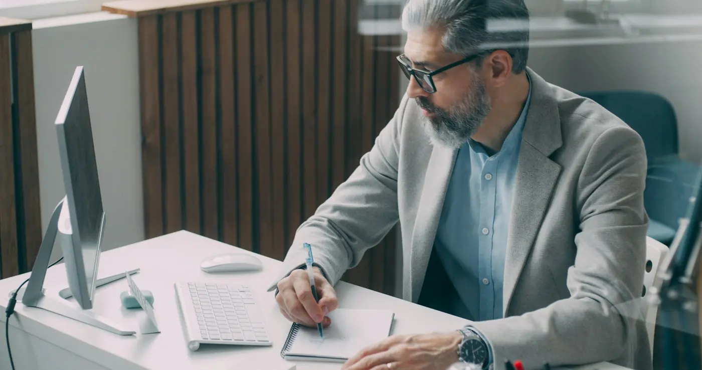 Executive reviewing documents at a desk