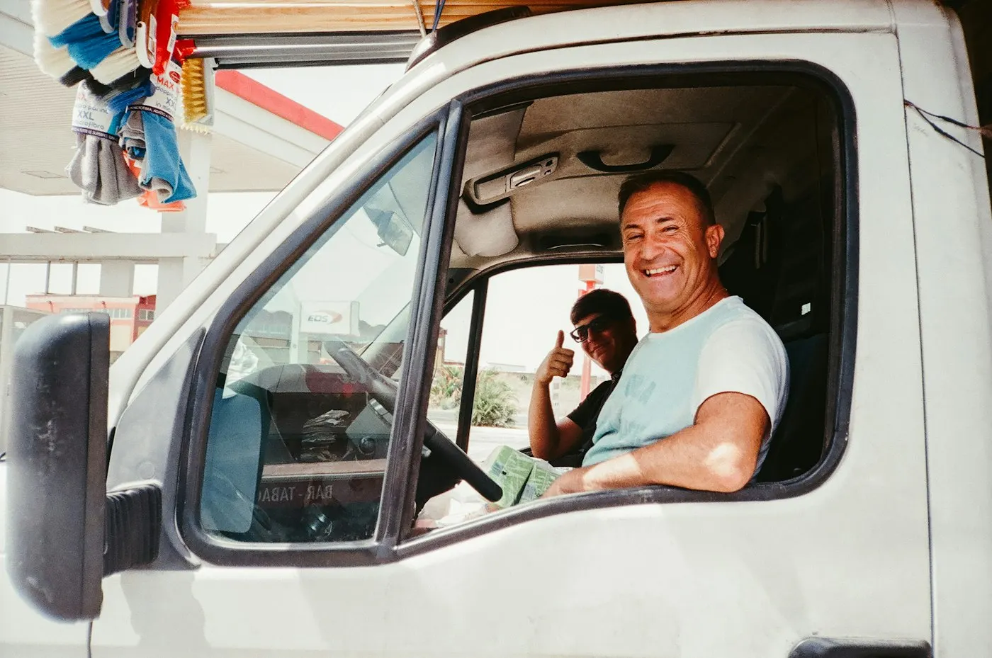 Smiling driver leaning out of a truck cab