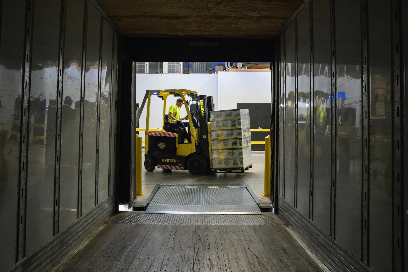 Forklift loading pallets into a trailer