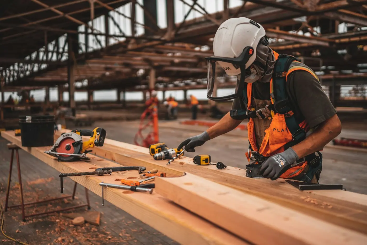 Worker in a hard hat holding a power tool